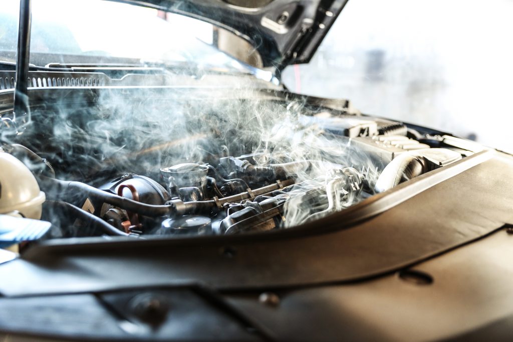 An engine overheating with the hood up. - Dann's Discount Auto Sales Visalia, CA