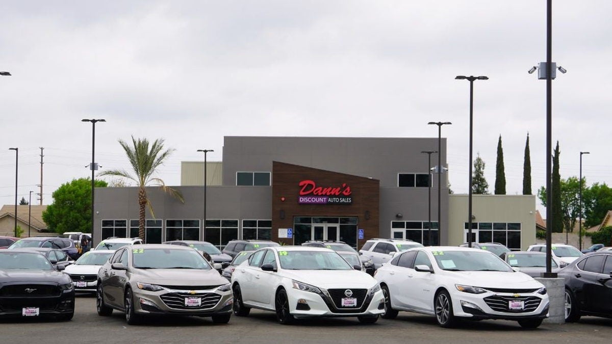 Rows of used cars, trucks, and SUVs for sale on the lot at Dann's Discount Auto Sales in Tulare CA
