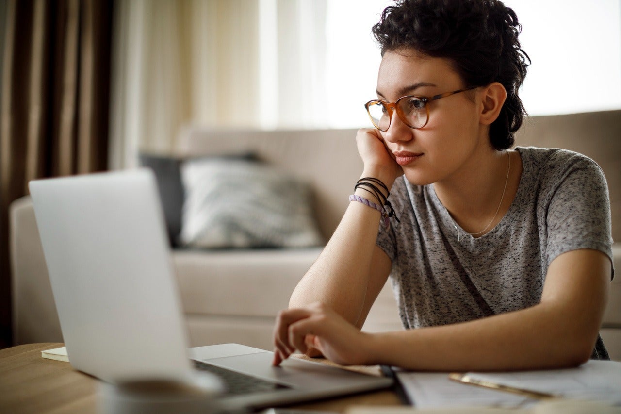 image of a woman looking at a laptop